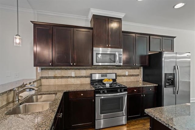 kitchen with hanging light fixtures, crown molding, sink, and appliances with stainless steel finishes