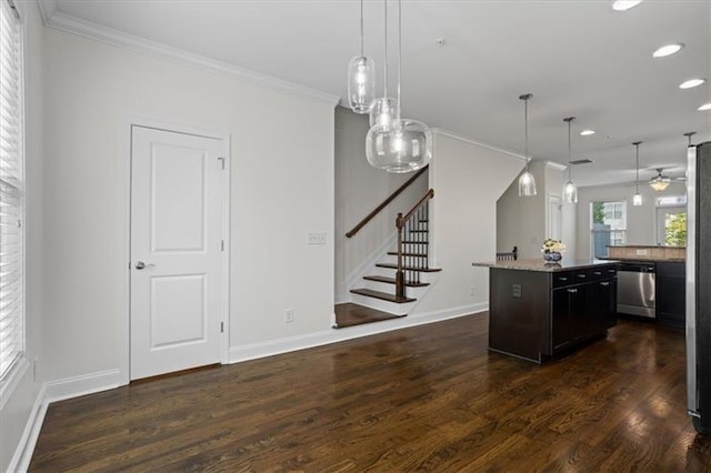 kitchen featuring dishwasher, a kitchen island, crown molding, and decorative light fixtures