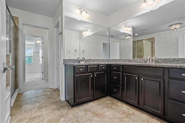 bathroom featuring vanity and a shower with shower door