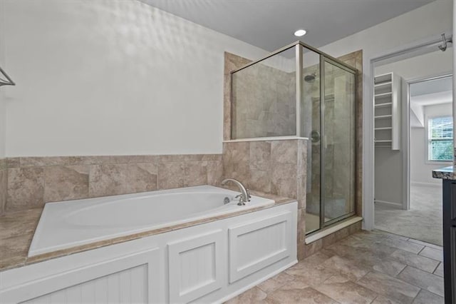 bathroom with vanity and shower with separate bathtub