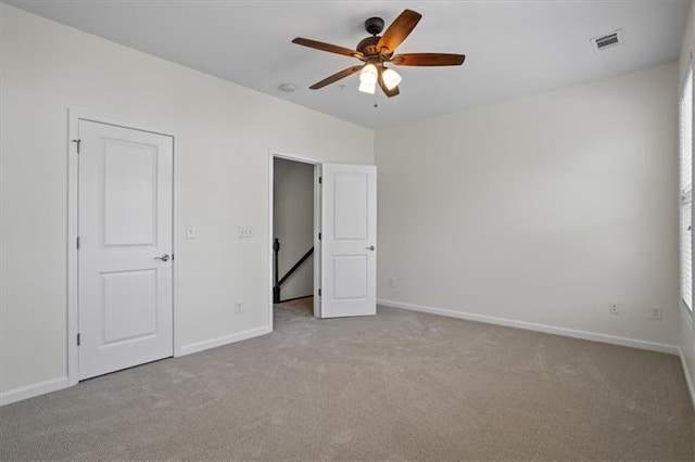 unfurnished bedroom featuring ceiling fan and light carpet