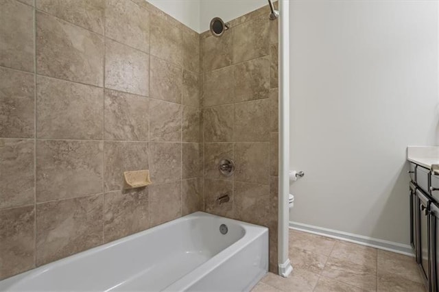 bathroom featuring tiled shower / bath and vanity