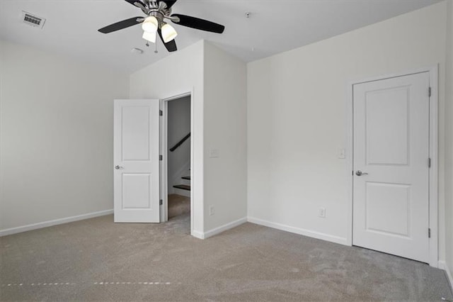 unfurnished bedroom with light carpet and ceiling fan