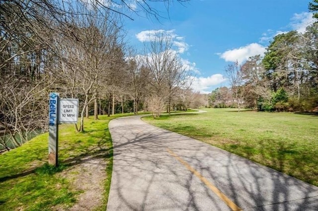 view of property's community with a lawn