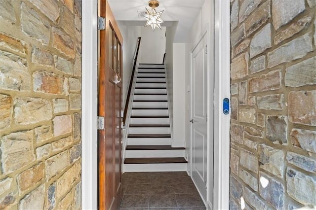 staircase featuring tile patterned flooring