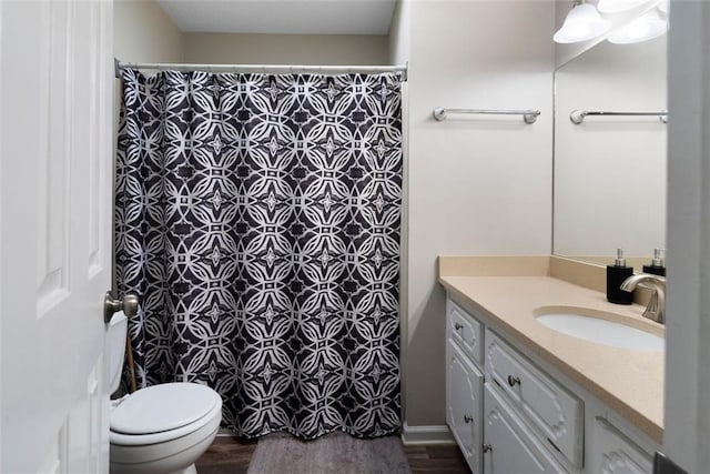 full bath featuring toilet, curtained shower, wood finished floors, and vanity