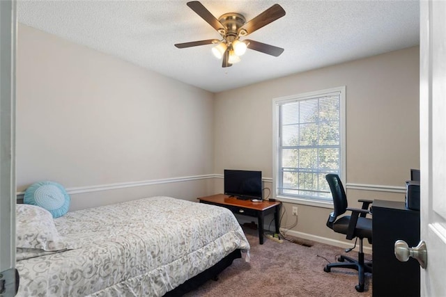 carpeted bedroom with a textured ceiling, ceiling fan, and baseboards