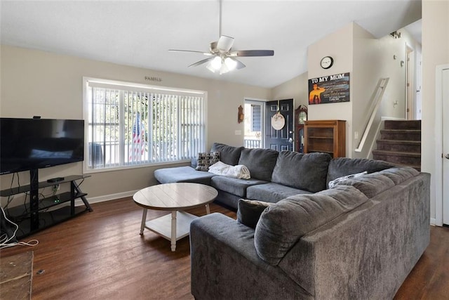 living room with baseboards, a ceiling fan, lofted ceiling, dark wood-style flooring, and stairs