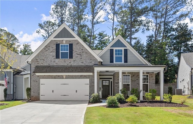 craftsman inspired home with central air condition unit, a garage, and a front yard