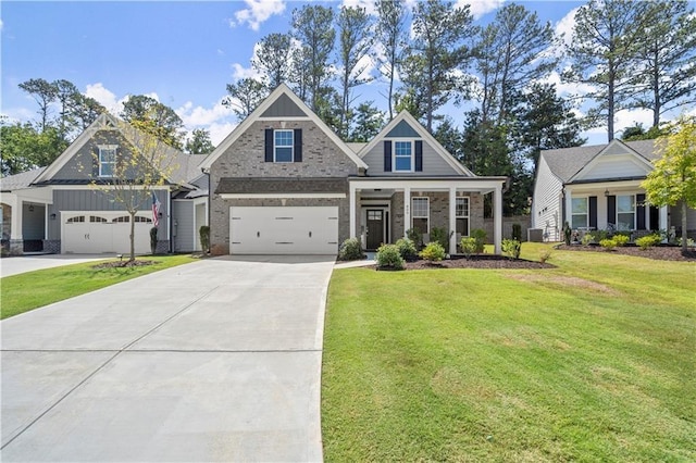 craftsman inspired home featuring covered porch, a garage, and a front yard