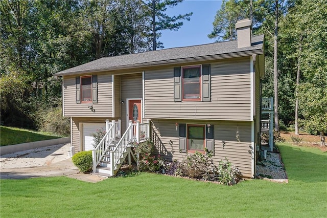 bi-level home featuring a front lawn and a garage