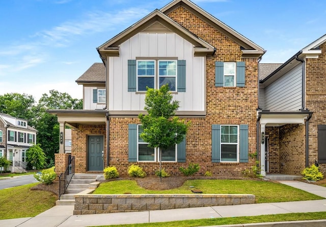 947 Edwin Ln, Sugar Hill, GA 30518 - view of front facade with board and batten siding, brick siding, and a front lawn