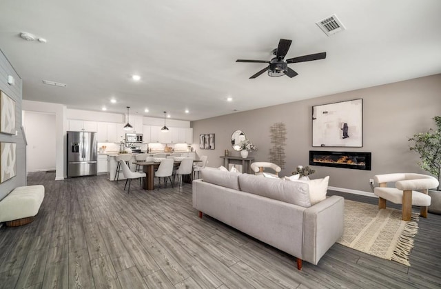 947 Edwin Ln, Sugar Hill, GA 30518 - living room with a glass covered fireplace, recessed lighting, dark wood-style floors, and a ceiling fan