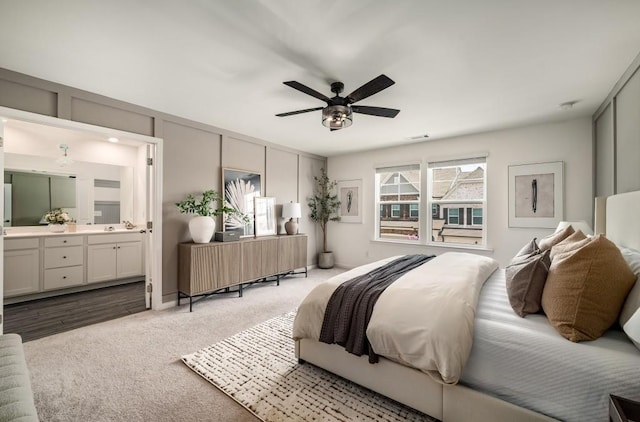 947 Edwin Ln, Sugar Hill, GA 30518 - carpeted bedroom with ensuite bathroom and ceiling fan