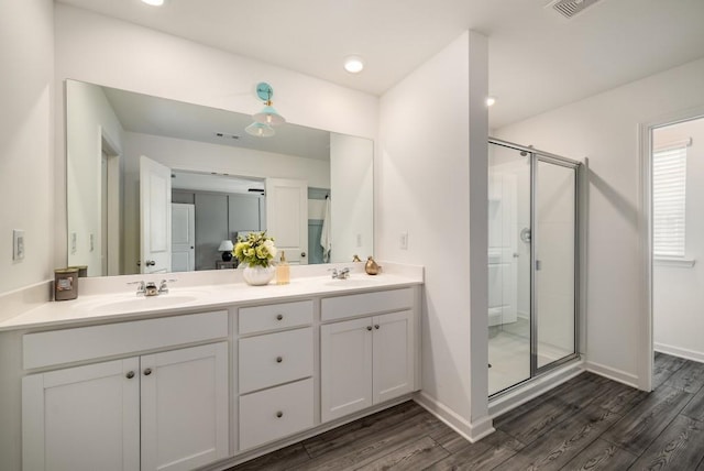 947 Edwin Ln, Sugar Hill, GA 30518 - bathroom featuring a shower stall, double vanity, and wood finished floors