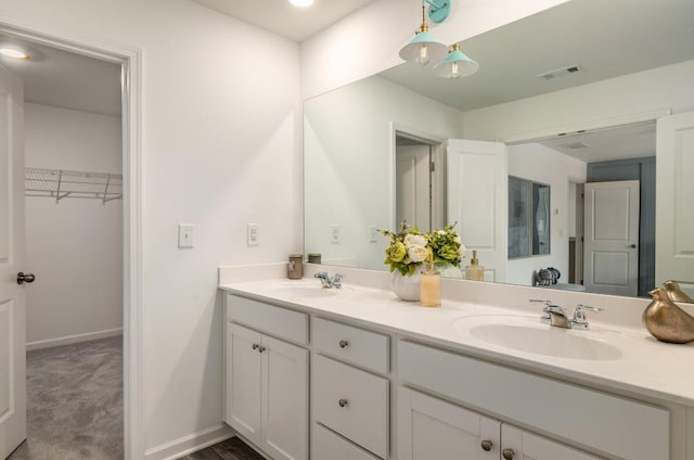 947 Edwin Ln, Sugar Hill, GA 30518 - bathroom with double vanity and a walk in closet