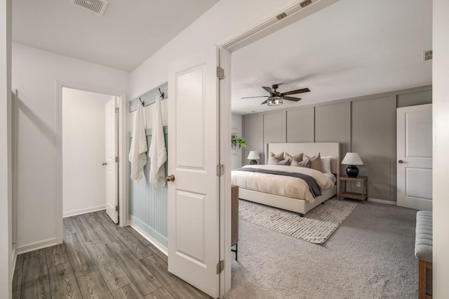 947 Edwin Ln, Sugar Hill, GA 30518 - bedroom with a decorative wall, wood finished floors, and a ceiling fan