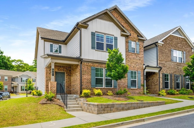 947 Edwin Ln, Sugar Hill, GA 30518 - view of front of home featuring board and batten siding, brick siding, and a front lawn
