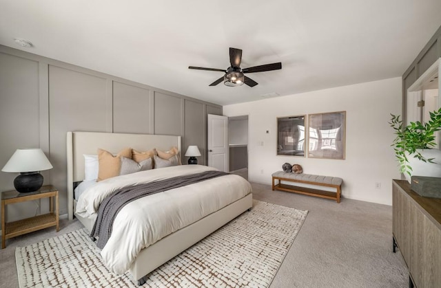 947 Edwin Ln, Sugar Hill, GA 30518 - bedroom with light colored carpet, a decorative wall, and a ceiling fan