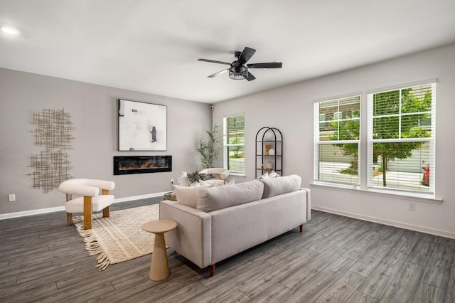 947 Edwin Ln, Sugar Hill, GA 30518 - living area featuring dark wood-style flooring, ceiling fan, and a glass covered fireplace