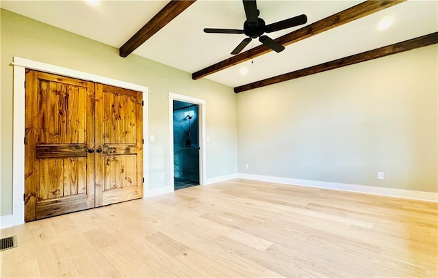 unfurnished bedroom featuring beam ceiling, ceiling fan, and light wood-type flooring