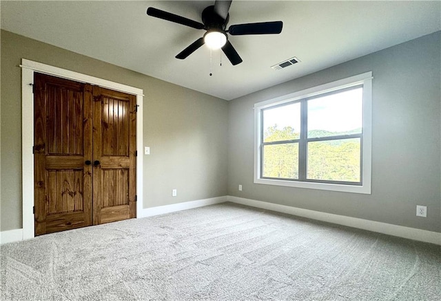 carpeted empty room with ceiling fan