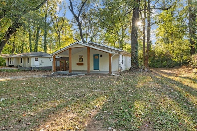 view of front of house with a front yard and a porch