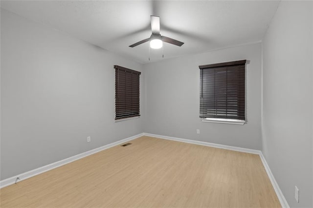 spare room featuring light hardwood / wood-style flooring and ceiling fan