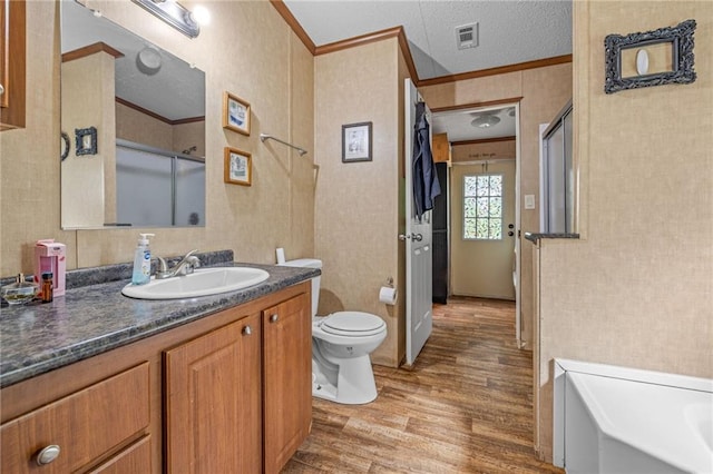 2860 Jack Bryant Cir, Gainesville, GA 30507 - full bathroom featuring wood finished floors, crown molding, toilet, an enclosed shower, and vanity