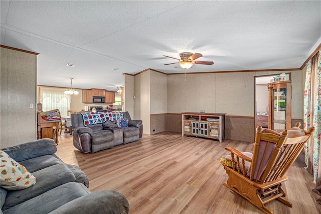 2860 Jack Bryant Cir, Gainesville, GA 30507 - living area with light wood-type flooring, crown molding, healthy amount of natural light, a ceiling fan, and a textured ceiling
