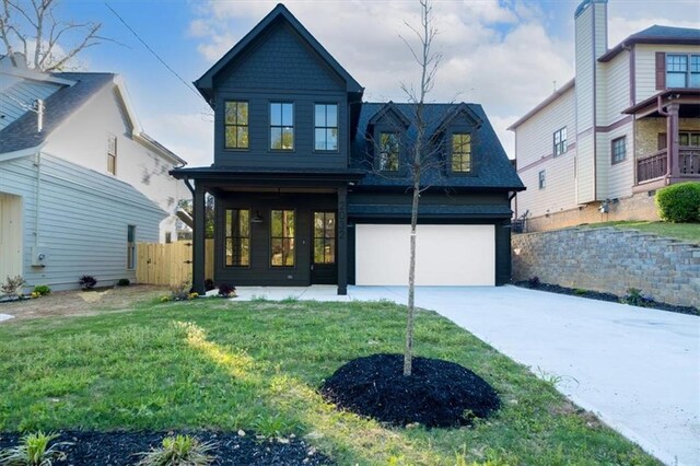 view of front of property with a garage and a front lawn