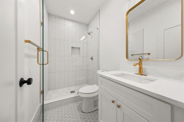 bathroom with vanity, tile patterned floors, toilet, and walk in shower