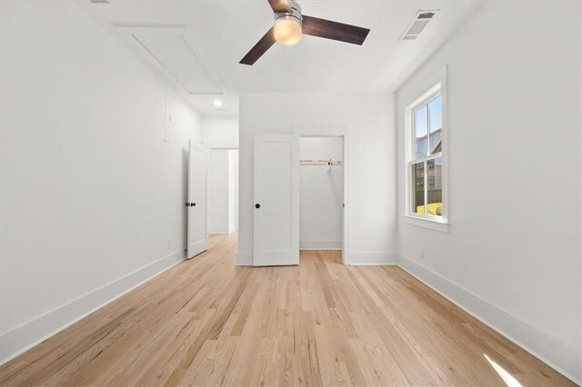 unfurnished bedroom with a closet, light hardwood / wood-style floors, and ceiling fan