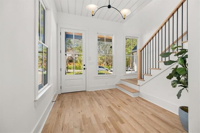 doorway featuring wood ceiling and light wood-type flooring