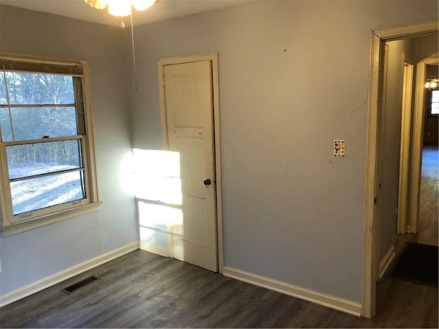 empty room with dark wood-type flooring