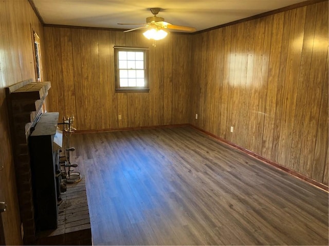 unfurnished living room with ceiling fan, ornamental molding, and dark hardwood / wood-style flooring