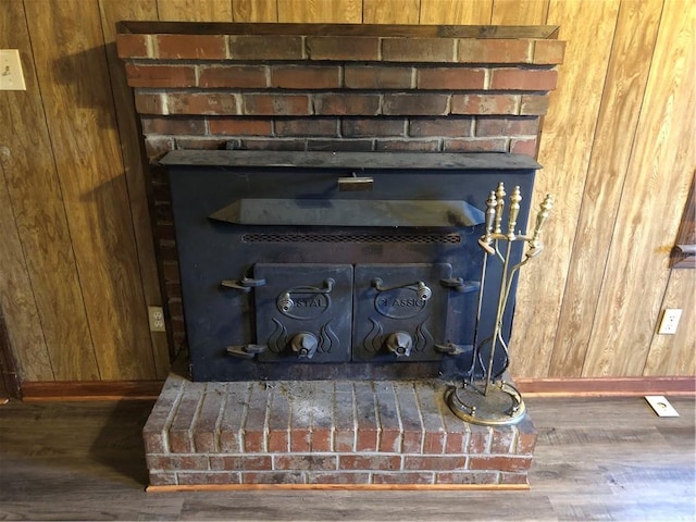 details with wood-type flooring, a wood stove, and wooden walls