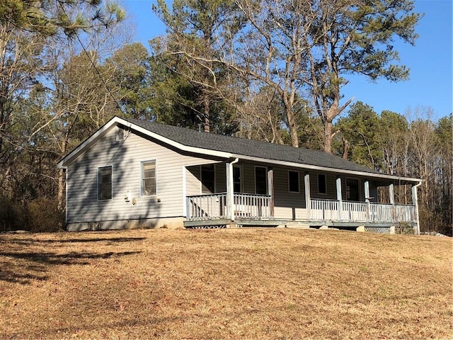 ranch-style house with a front yard and covered porch