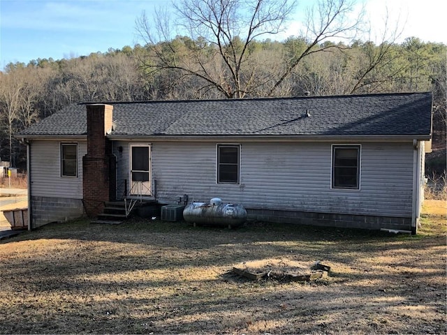 back of house with central air condition unit