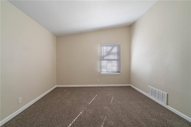 spare room featuring baseboards, visible vents, and carpet flooring