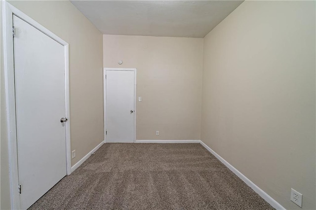 empty room with carpet and baseboards