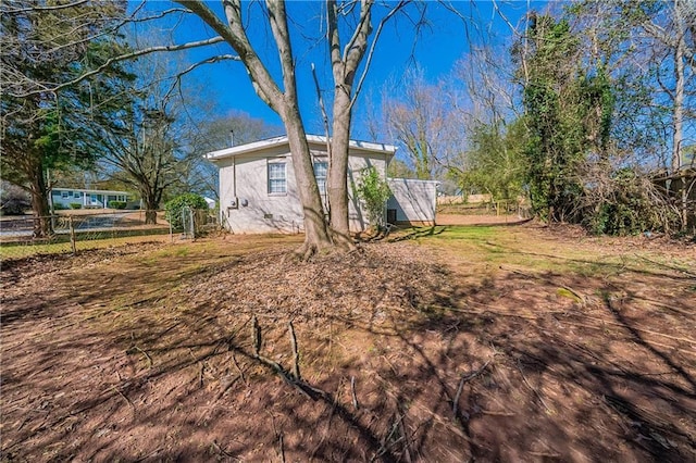 view of side of property featuring fence