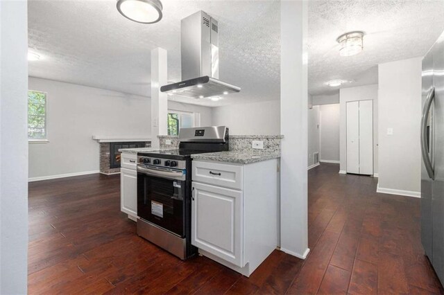 1781 Jajef Ave, Conley, GA 30288 - kitchen with wall chimney range hood, dark wood-style floors, stainless steel appliances, and a textured ceiling