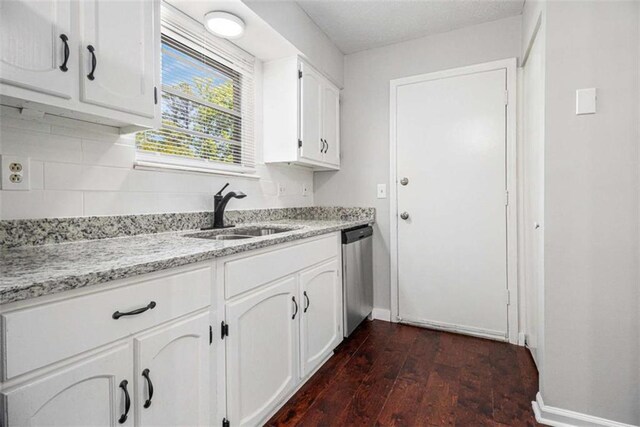 1781 Jajef Ave, Conley, GA 30288 - kitchen with light stone counters, a sink, white cabinets, dishwasher, and dark wood finished floors
