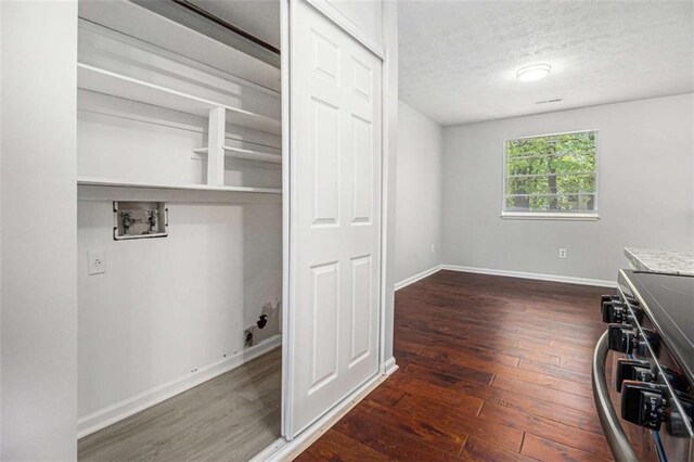 1781 Jajef Ave, Conley, GA 30288 - clothes washing area with laundry area, wood-type flooring, hookup for a washing machine, baseboards, and a textured ceiling