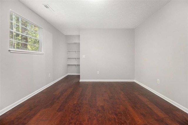 1781 Jajef Ave, Conley, GA 30288 - spare room featuring baseboards, wood finished floors, a textured ceiling, and built in shelves