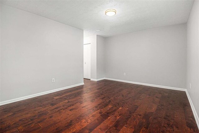 1781 Jajef Ave, Conley, GA 30288 - unfurnished room featuring baseboards, dark wood-style flooring, and a textured ceiling