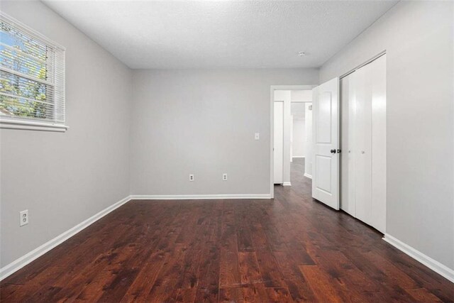 1781 Jajef Ave, Conley, GA 30288 - unfurnished bedroom with baseboards, wood finished floors, and a closet