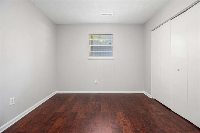 1781 Jajef Ave, Conley, GA 30288 - unfurnished bedroom with visible vents, baseboards, a closet, and wood-type flooring