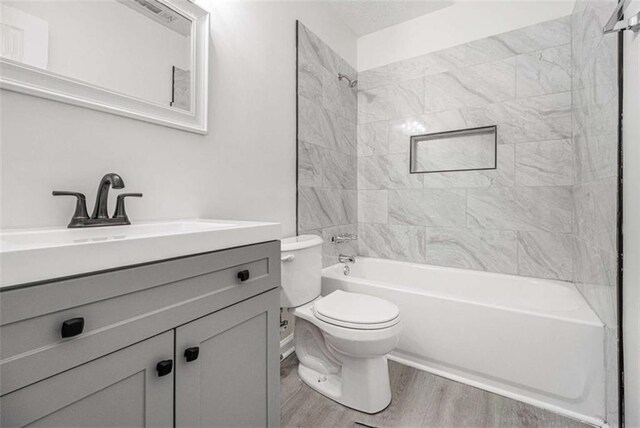 1781 Jajef Ave, Conley, GA 30288 - full bath with toilet, vanity, wood finished floors, and bathing tub / shower combination